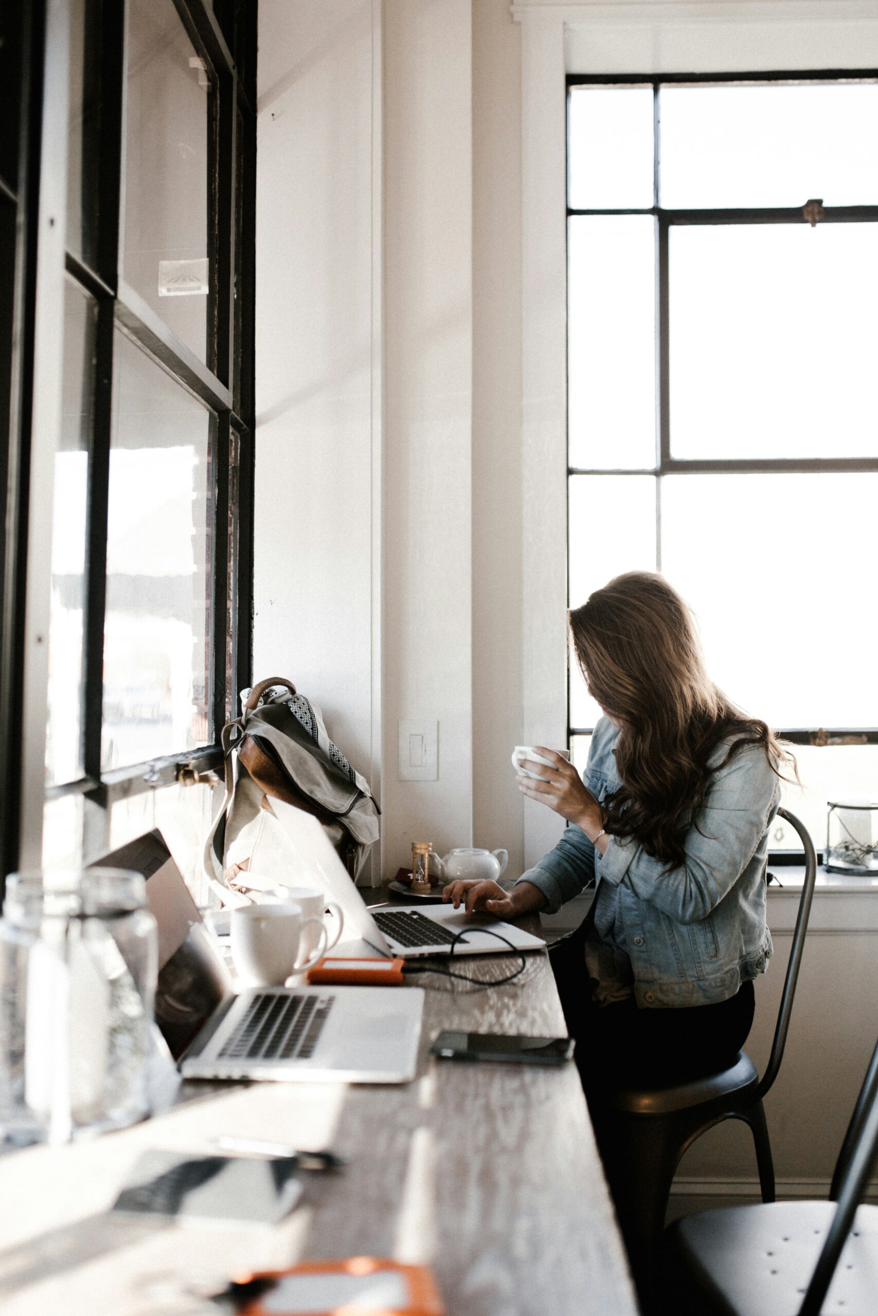 A travel advisor working on a laptop, symbolizing business growth and delegation in the travel industry.